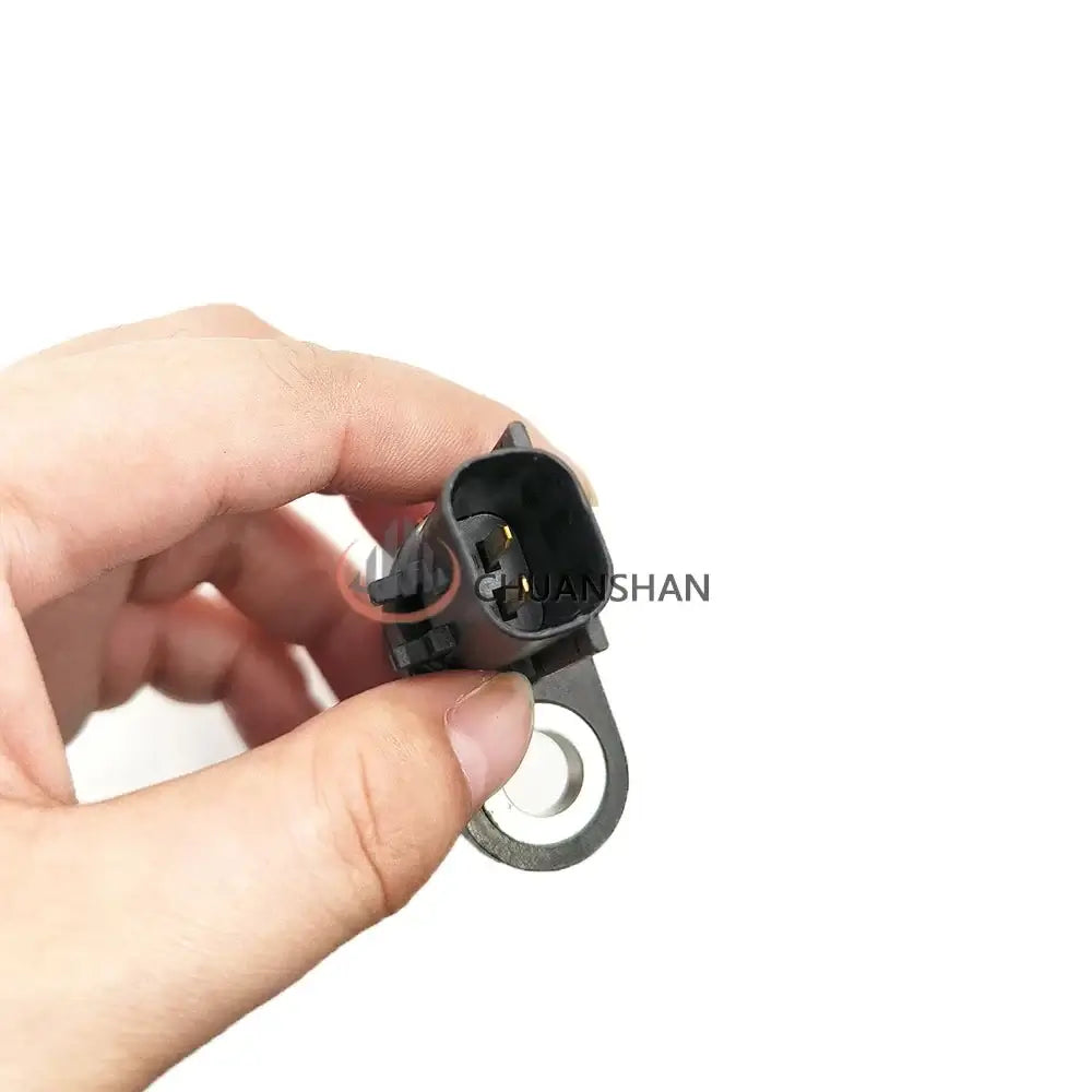 Hand holding Revolution Sensor Gp-Sp Crankshaft Position Sensor 384-3887 for Caterpillar Marine Engine.